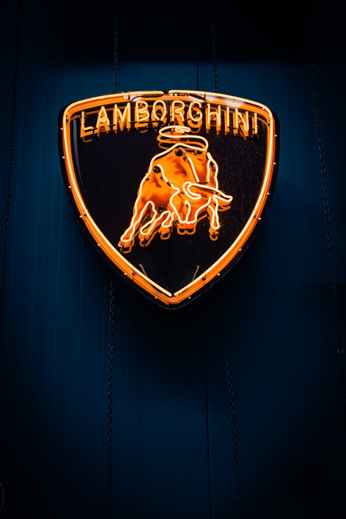 A vibrant neon Lamborghini logo glowing in the night in İzmir, Türkiye, exuding luxury and elegance.